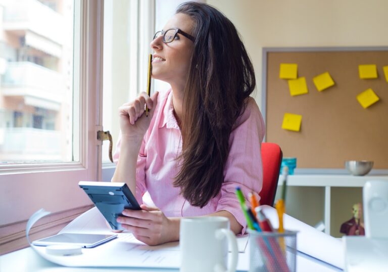 Portrait of beautiful young woman working in her office.